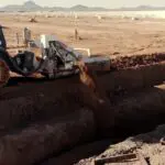 A construction vehicle is digging into the ground.