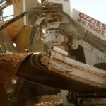 A close up of the front end of an excavator.