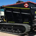 A black dump truck with tracks on the side.