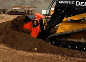 A yellow and black tractor is digging in the ground