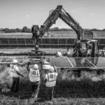 A black and white photo of workers in the field